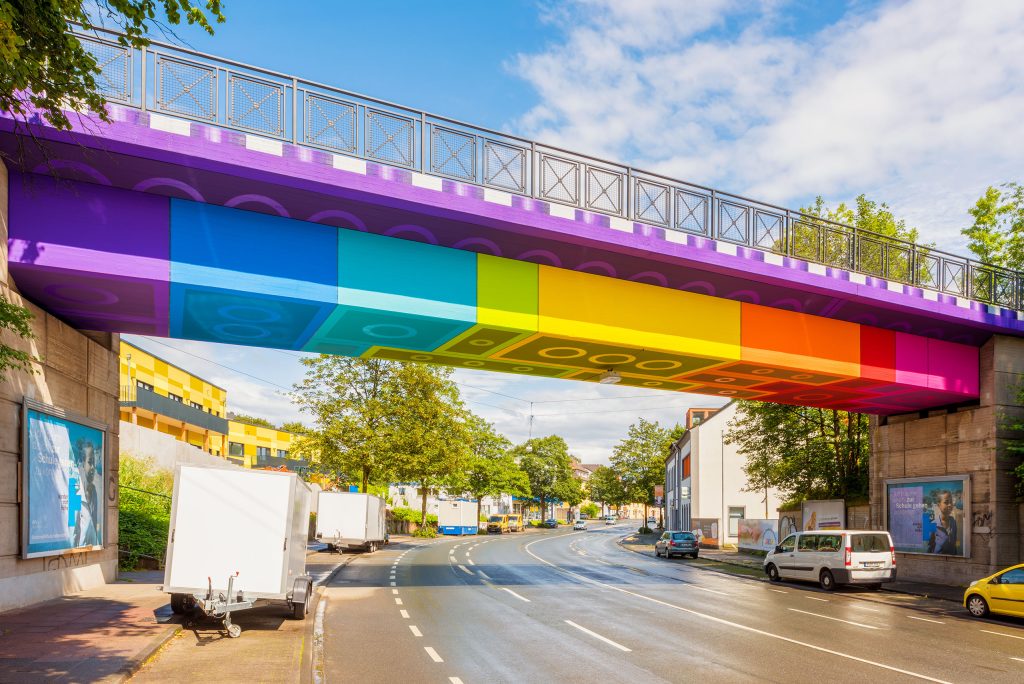 A side view of a bridge with colorful lego blocks on the bottom