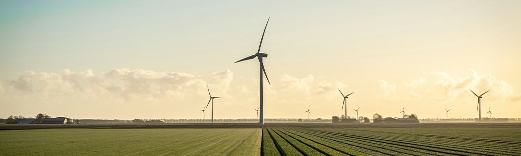 side view of a wind turbines located on a farm field