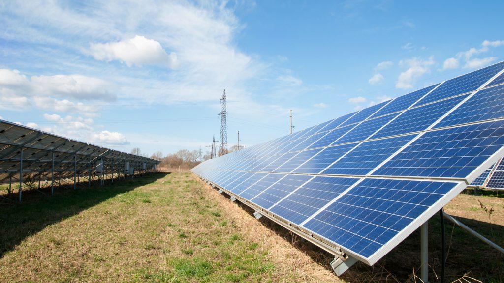 Solar panels next to a power grid