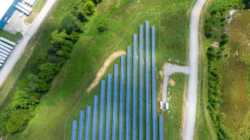 green field with solar panels view from above