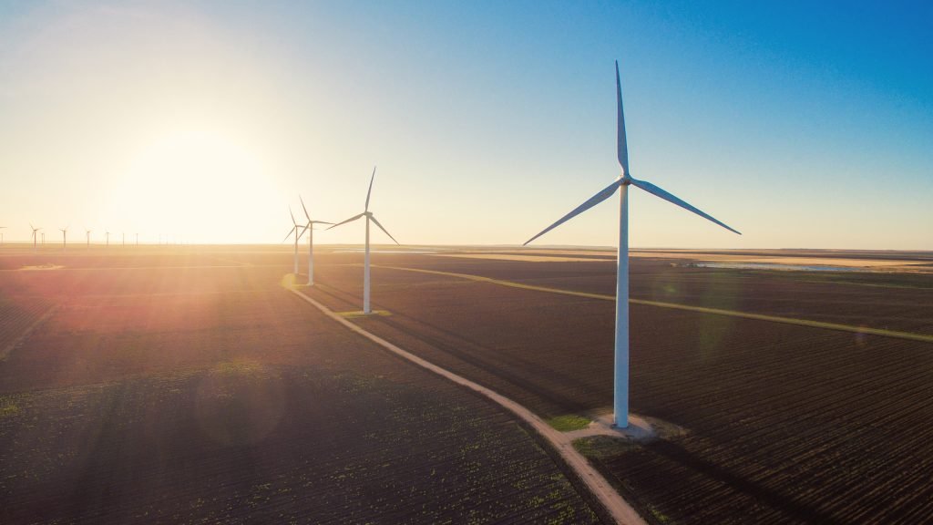 Aerial view of wind turbines at sunset